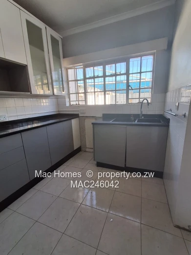 Bright 2-Bed Garden Flat Harare CBD — Water Tank & Carport