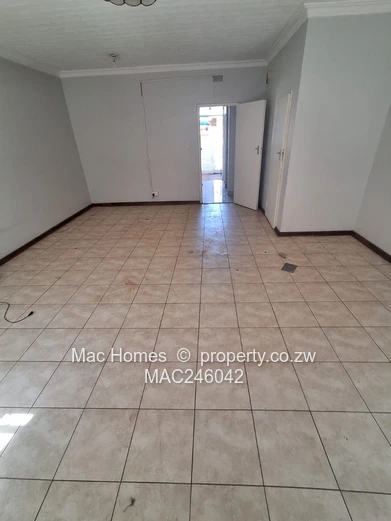 Bright 2-Bed Garden Flat Harare CBD — Water Tank & Carport