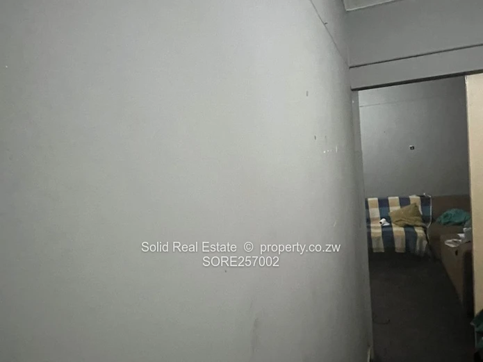 Harare CBD 1BR Ground-Floor Flat — Brick Facade & Cupboards