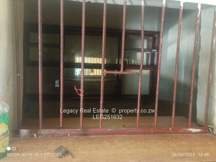 Tiled, High-Ceiling Retail Shop with Service Hatch — Chitungwiza