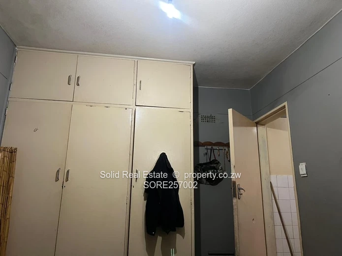 Harare CBD 1BR Ground-Floor Flat — Brick Facade & Cupboards