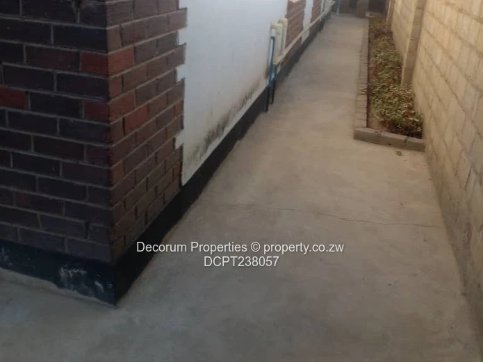 Chitungwiza: 2-Bed, 4-Bath Walled Brick Home, Paved Yard