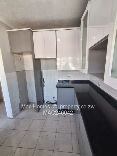 Bright 2-Bed Garden Flat Harare CBD — Water Tank & Carport