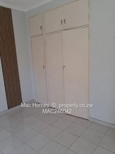 Bright 2-Bed Garden Flat Harare CBD — Water Tank & Carport