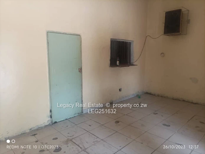Tiled, High-Ceiling Retail Shop with Service Hatch — Chitungwiza