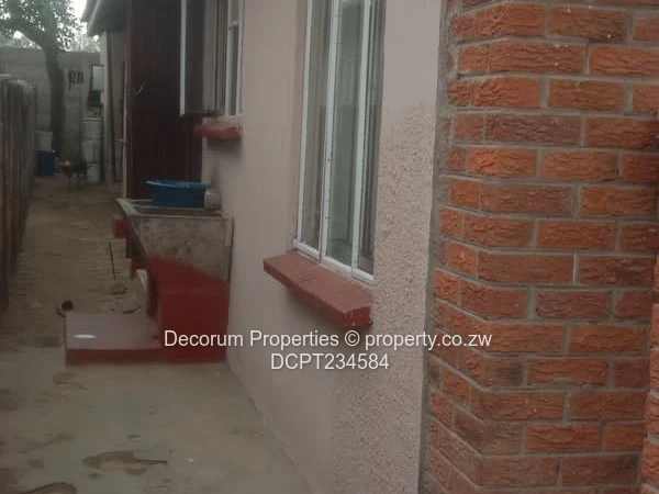 Brick-Front 4-Bed Walled Home in Ruwa — Tiled Floors