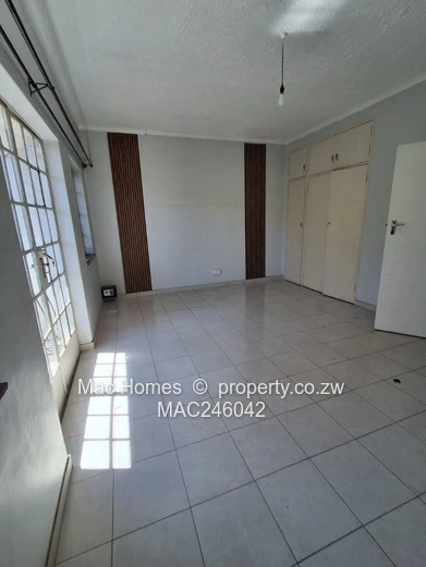 Bright 2-Bed Garden Flat Harare CBD — Water Tank & Carport