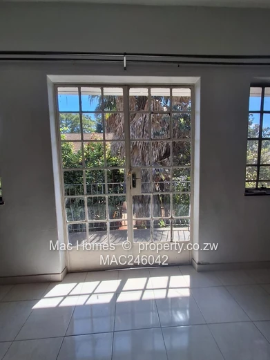 Bright 2-Bed Garden Flat Harare CBD — Water Tank & Carport