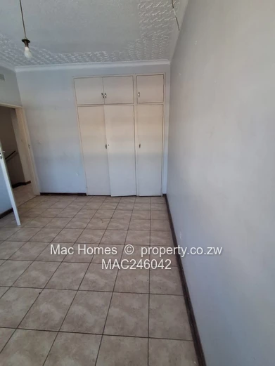 Bright 2-Bed Garden Flat Harare CBD — Water Tank & Carport